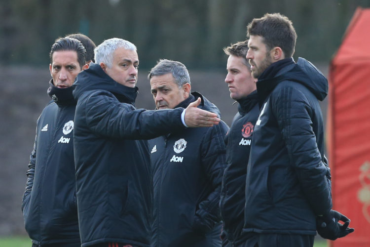 Manchester United's Portuguese manager Jose Mourinho (2L) looks on during a training session at the Carrington Training complex in Manchester, nort...