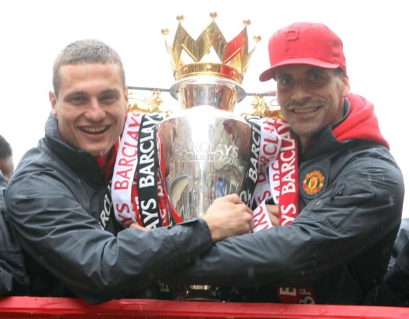 Rio Ferdinand (L) and Nemanja Vidic of Manchester United pose with the Barclays Premier League trophy during the Manchester United Premier League W...