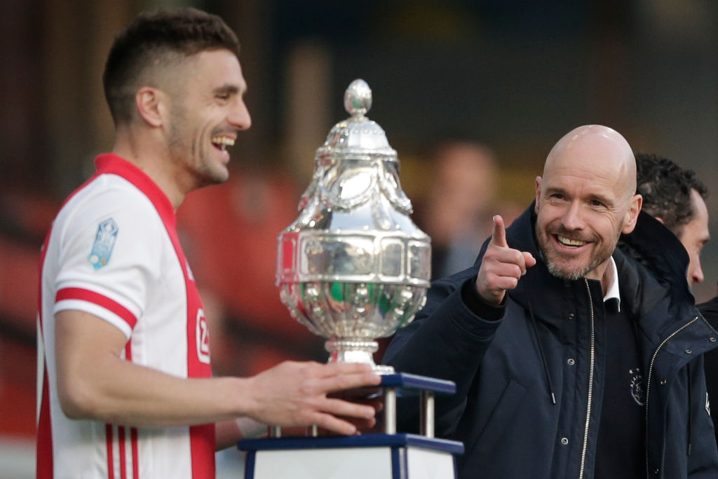 Ajaxs head coach Erik ten Hag (R) gestures as captain Dusan Tadic is about to lift the trophy after winning the TOTO KNVB Cup final soccer match be...