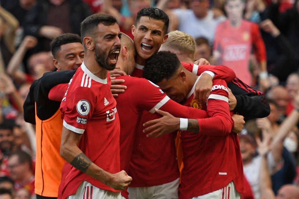 Manchester United's Portuguese striker Cristiano Ronaldo (C) celebrates with teammates after scoring their second goal during the English Premier L...