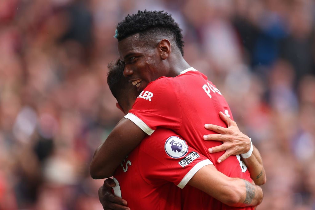 Bruno Fernandes of Manchester United celebrates with teammate Paul Pogba after scoring their side's fourth goal and his hat-trick during the Premie...