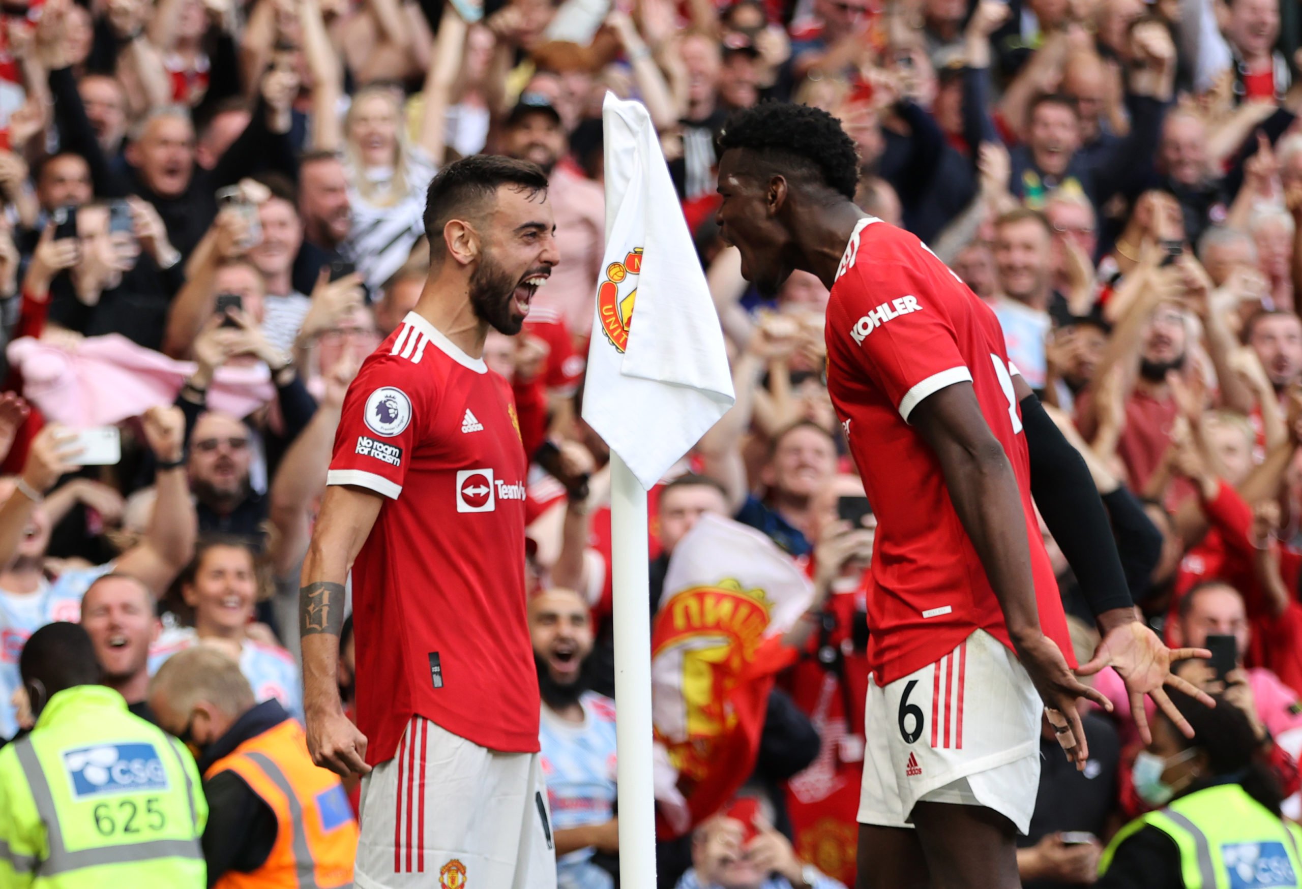 Bruno Fernandes of Manchester United celebrates with Paul Pogba after scoring their side's third goal during the Premier League match between Manch...