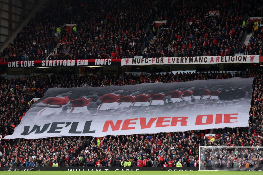 Manchester United fans hold up a flag in honour of the victims of the Munich Air disaster during the Premier League match between Manchester United...