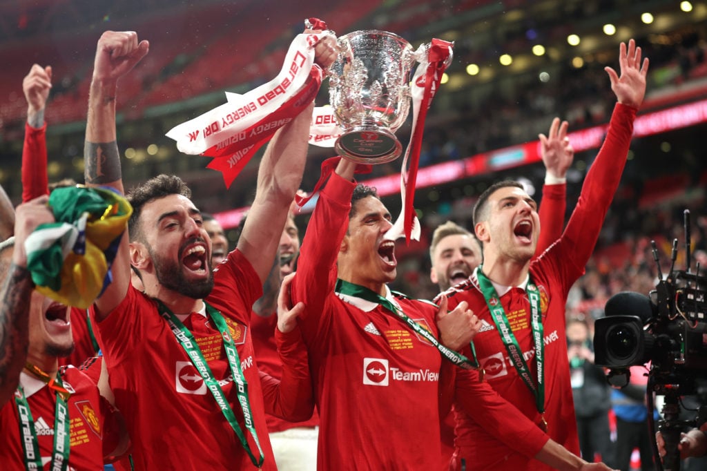 Bruno Fernandes and Raphael Varane of Manchester United celebrate with the Carabao Cup trophy following victory in the Carabao Cup Final match betw...