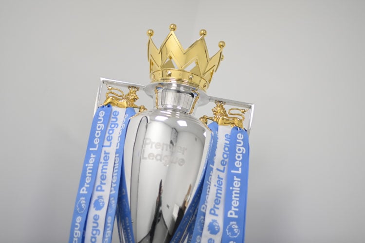 A general view of the Premier League trophy with Manchester City coloured blue and white ribbons during the Premier League match between Manchester...