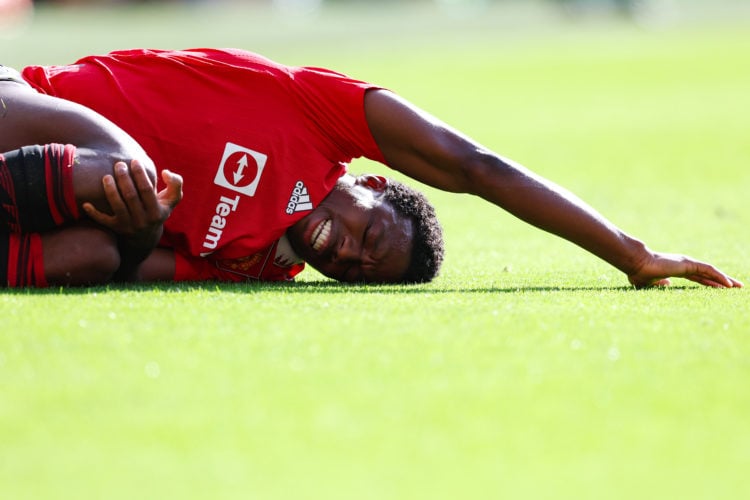 Tyrell Malacia of Manchester United lies injured on the pitch during the Premier League match between Manchester United and Fulham FC at Old Traffo...