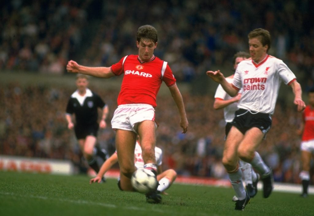 Steve Nicholl (right) of Liverpool comes in to tackle Norman Whiteside (left) of Manchester United during a Canon League Division One match at Old ...