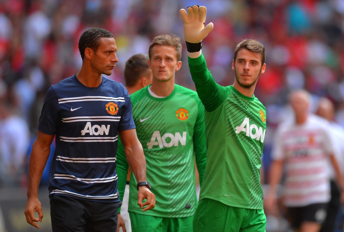 Rio Ferdinand of Manchester United looks on as team mate David De Gea waves to fans after victory in the FA Community Shield match between Manchest...