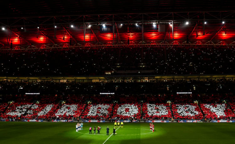 Players of both side's take part in a minutes applause in remembrance of Sir Bobby Charlton CBE as a 'Sir Bobby' tifo is displayed prior to during ...