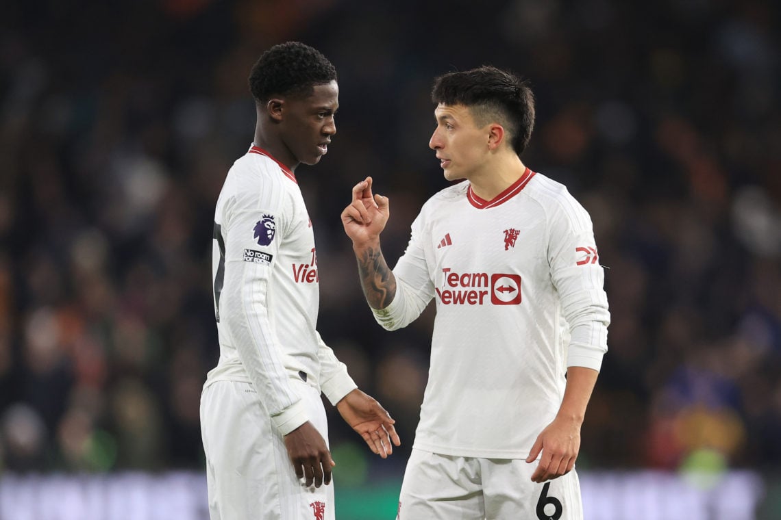 Lisandro Martinez of Manchester United (R) talks to Kobbie Mainoo of Manchester United during the Premier League match between Wolverhampton Wander...