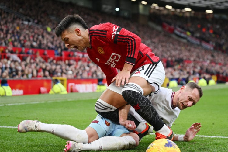 Lisandro Martinez of Manchester United injures his leg in this challenge with Vladimir Coufal of West Ham United battles for possession with during...