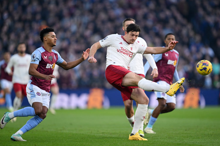 Harry Maguire of Manchester United shoots under pressure from Ollie Watkins of Aston Villa during the Premier League match between Aston Villa and ...