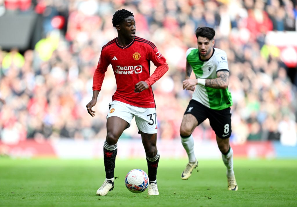 Kobbie Mainoo of Manchester United runs with the ball during the Emirates FA Cup Quarter Final between Manchester United and Liverpool FC at Old Tr...