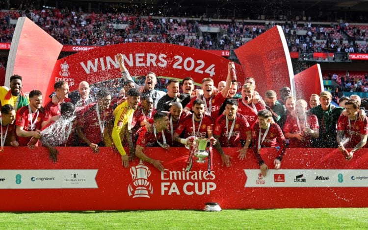 Manchester United's Portuguese midfielder #08 Bruno Fernandes  lifts the trophy to celebrate their victory at the end of the English FA Cup final f...