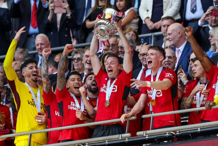 Manchester United's Jonny Evans lifts the trophy with teammates during the Emirates FA Cup Final match between Manchester City and Manchester Unite...