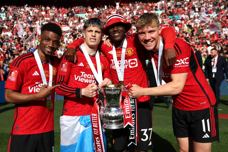 Amad Diallo, Alejandro Garnacho, Kobbie Mainoo and Rasmus Hojlund of Manchester United pose for a photograph with the Emirates FA Cup Trophy after ...