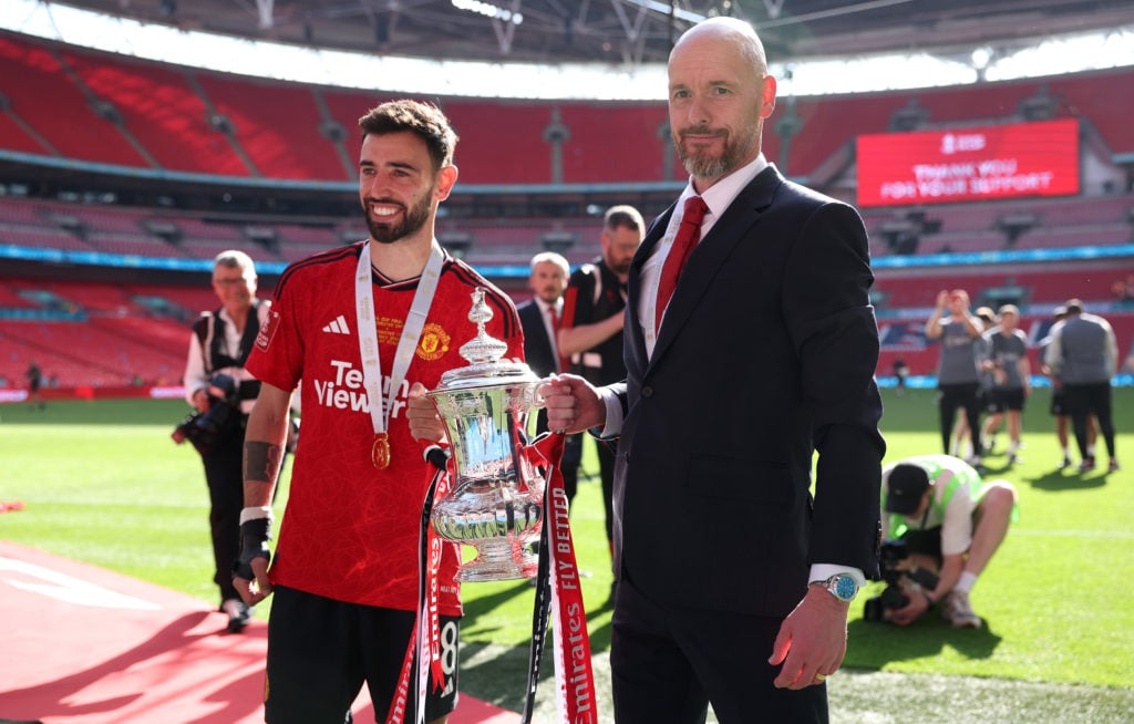 Bruno Fernandes of Manchester United lifts the FA Cup trophy with Erik ten Hag, manager of Manchester United, after the Emirates FA Cup Final match...