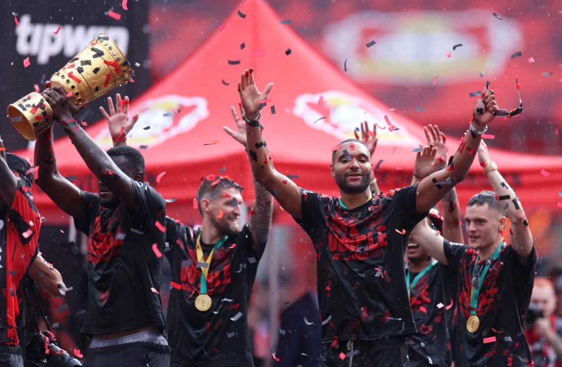 Jonathan Tah of Bayer 04 Leverkusen acknowledges the fans as he celebrates with teammates and the DFB-Pokal trophy during the Bayer 04 Leverkusen c...