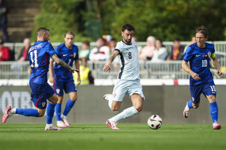 Marcelo Brozovic of Croatia (L) chases Bruno Fernandes of Portugal (R) during the International Friendly match between Portugal and Croatia at Esta...