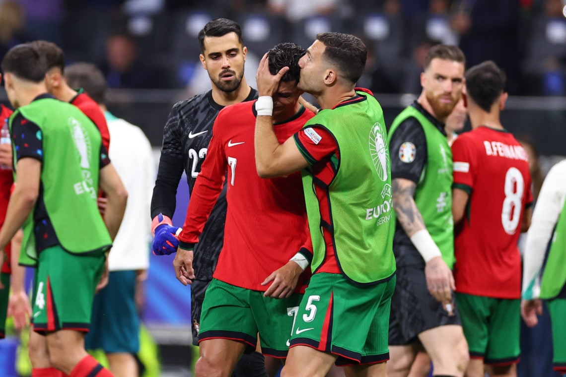 Cristiano Ronaldo of Portugal visibly upset after missing a penalty is spoken to by Diogo Dalot of Portugal during the UEFA EURO 2024 round of 16 m...