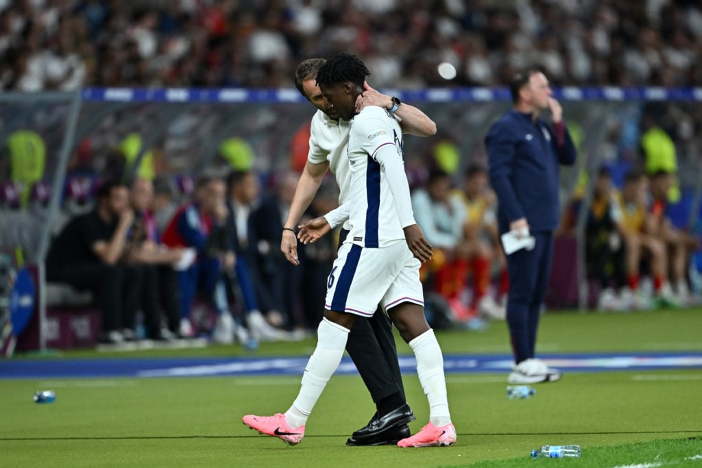 Gareth Southgate, Head Coach of England, interacts with Kobbie Mainoo of England as he leaves the field after being substituted during the UEFA EUR...