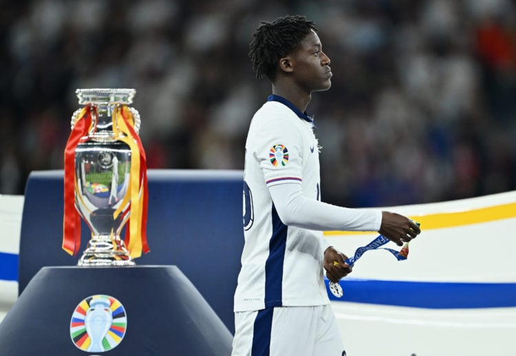 Kobbie Mainoo of England looks dejected as he walks past the UEFA Euro 2024 Henri Delaunay Trophy after collecting his Runners Up Medal after the U...