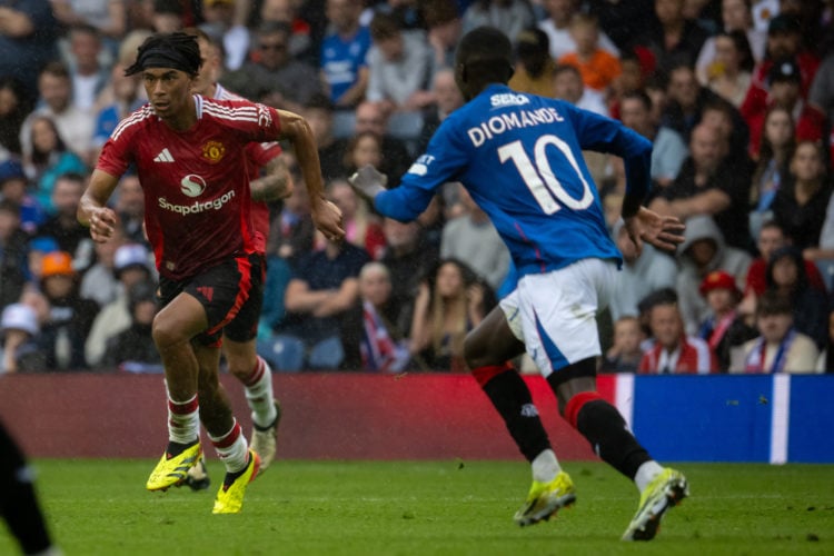 Maxi Oyedele of Manchester United in action with Mohamed Diomande of Glasgow Rangers during a pre-season friendly match between Manchester United v...