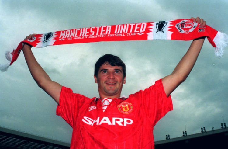 19 July 1993 - Roy Keane poses in a kit and holds a scarf after signing a contract with Manchester United.