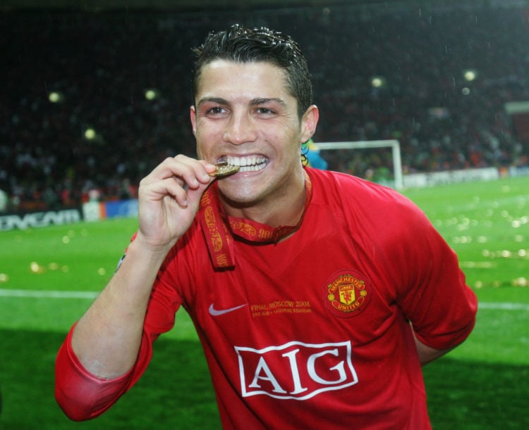 Cristiano Ronaldo of Manchester United bites his winners medal following his team's victory during the UEFA Champions League Final match between Ma...