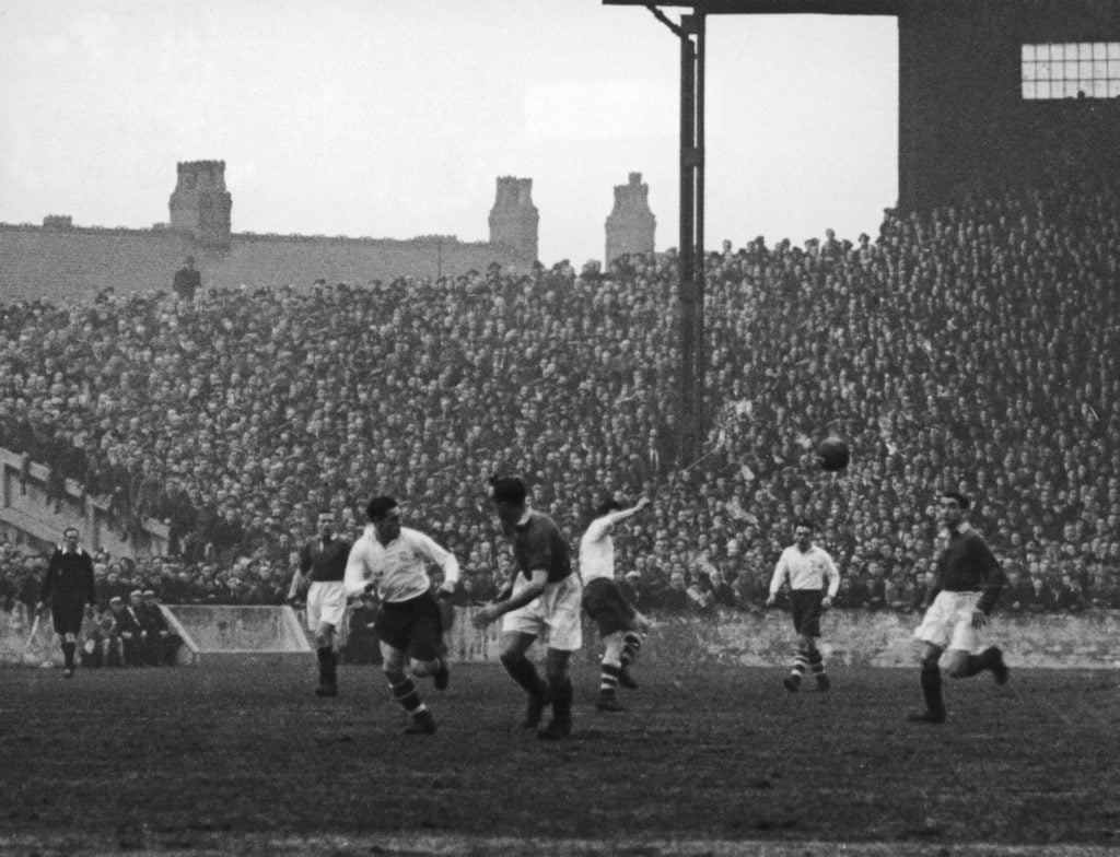 Preston North End players attempt to attack with a lob through the centre, but Manchester United players Mitten, Aston and Cockburn have them cover...