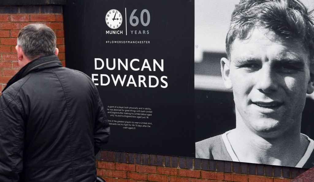 A picture shows a 60th anniversary commemoration poster showing the face of late Manchester United player Duncan Edwards who was killed in the 1958...