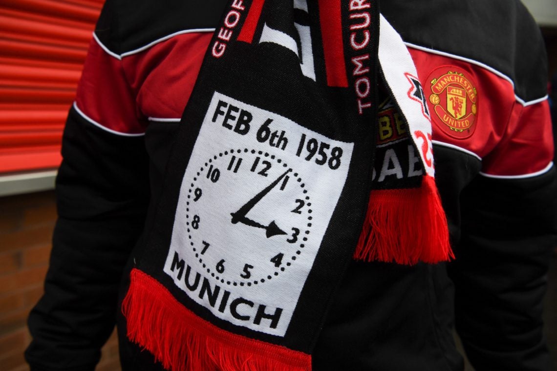 A supporter wears a scarf commemorating the 60th anniversary of the 1958 Munich Air Disaster with a clock showing the time of the crash that claime...