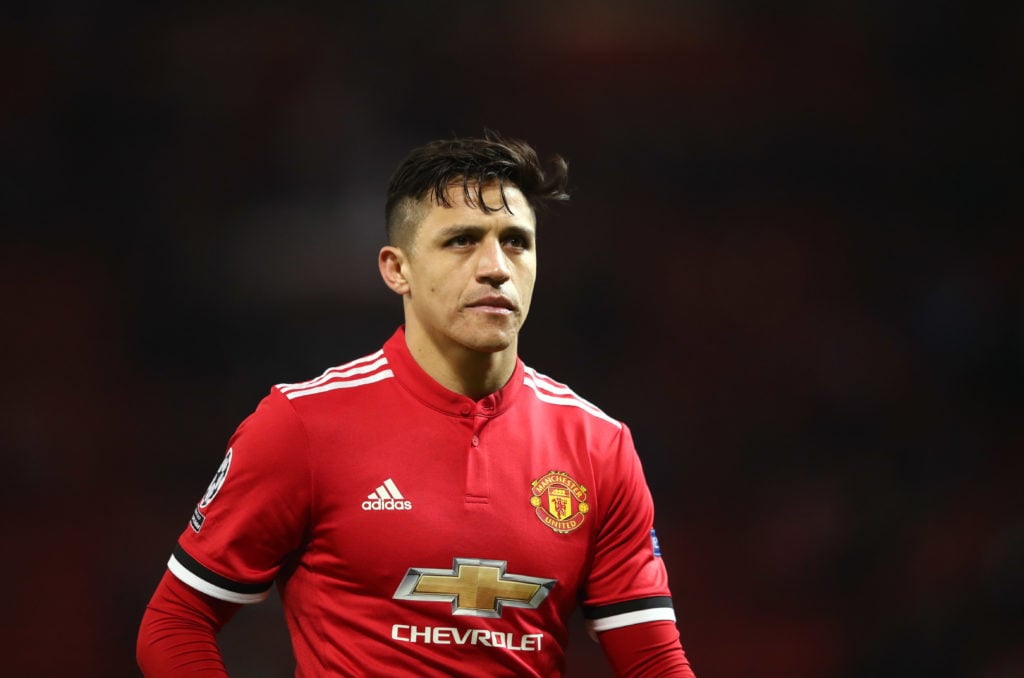 Alexis Sanchez of Manchester United looks dejected in defeat after the UEFA Champions League Round of 16 Second Leg match between Manchester United...